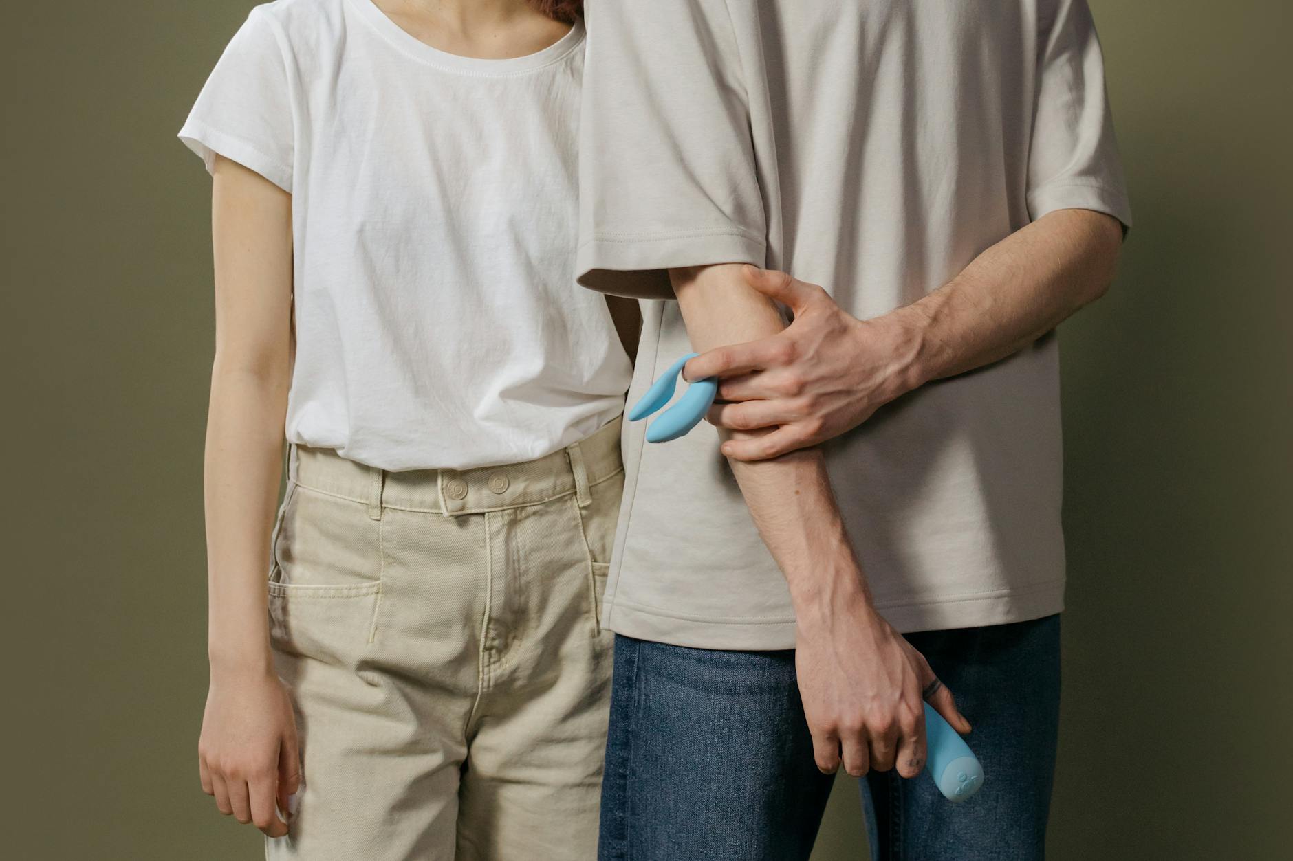 A couple holding an intimate conversation about pleasure while sitting together indoors.