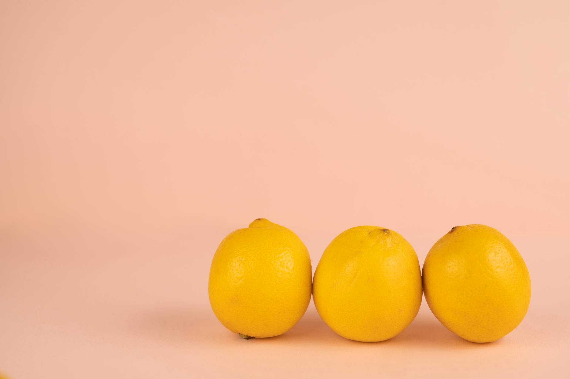 Bright ripe lemons on a pastel background representing fresh pleasure recovery
